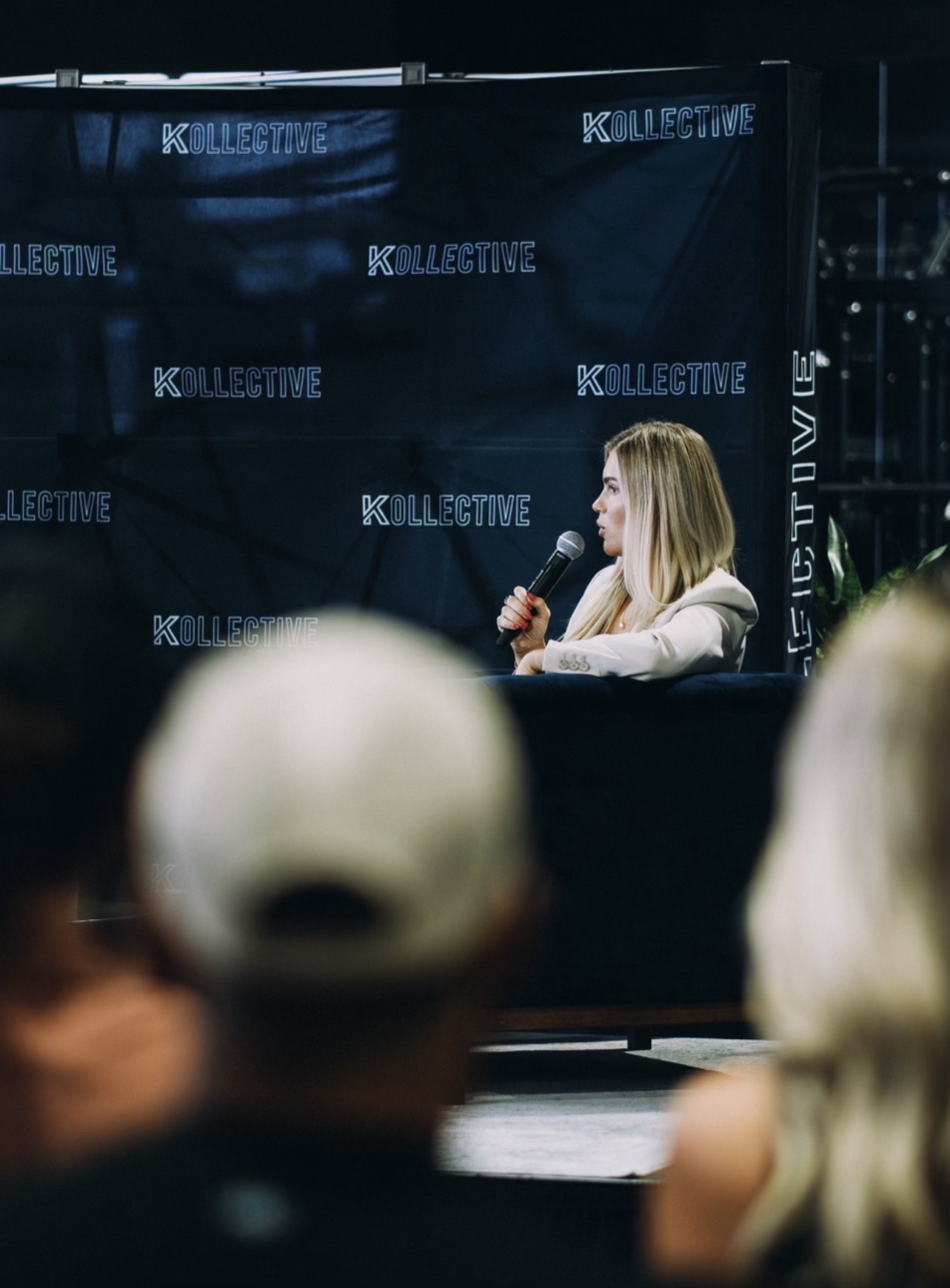 Speaker on stage at a Kollective member night