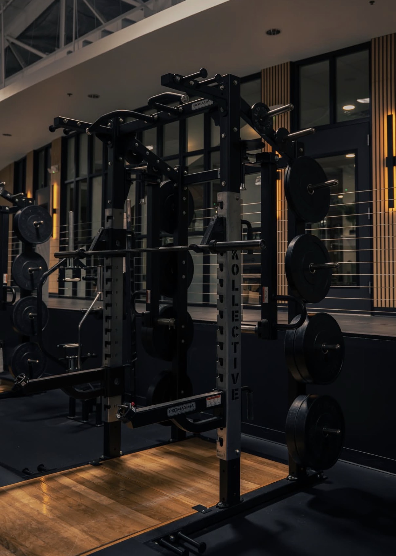Kollective-branded squat rack on the training floor