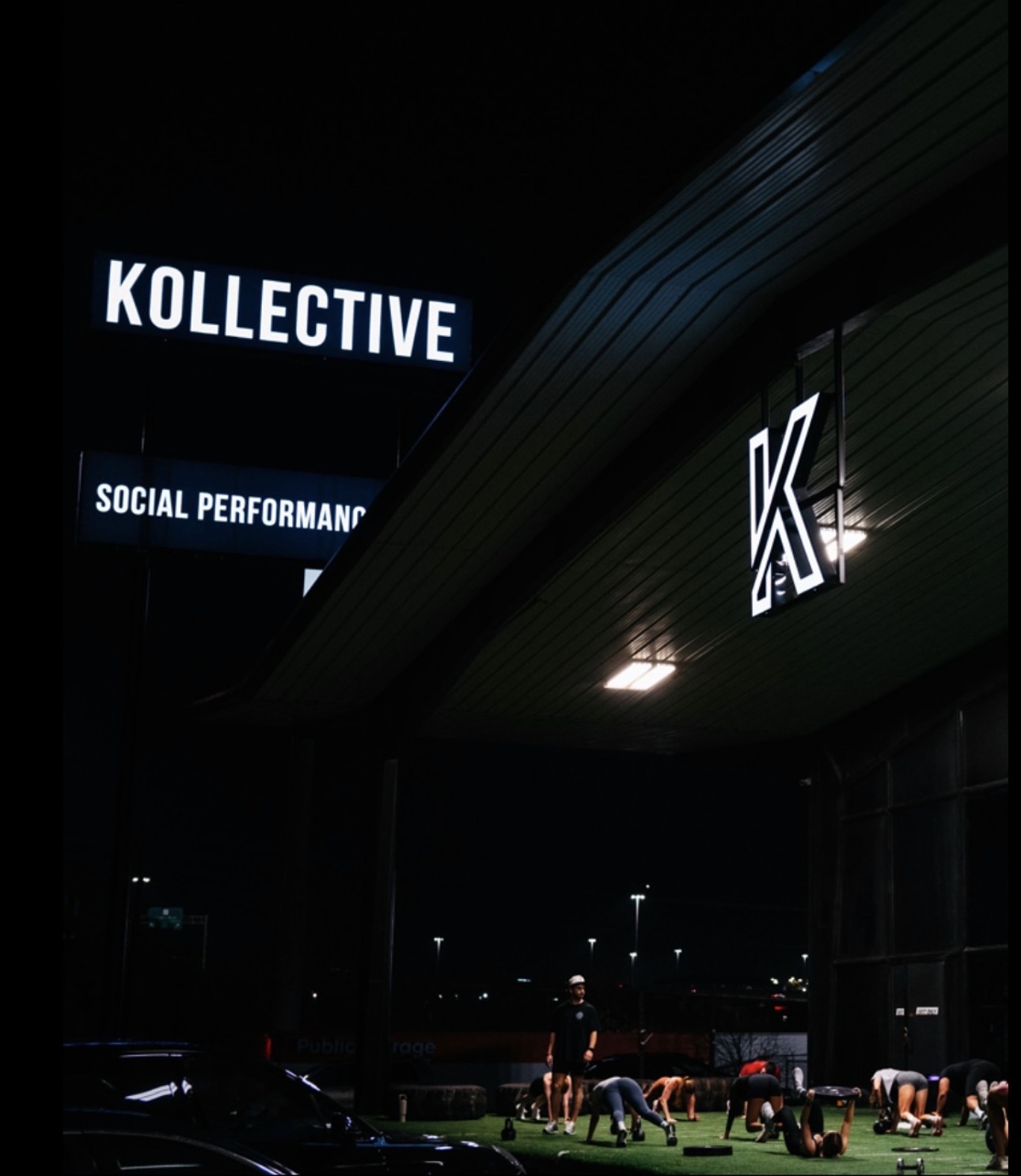 The Kollective North exterior at night with illuminated K signage