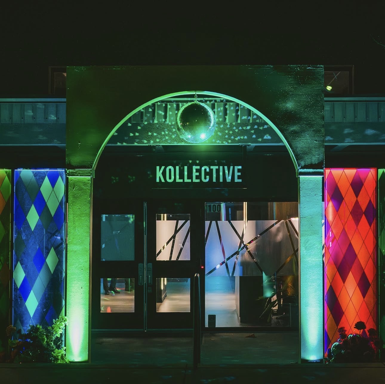 The Kollective entrance lit for an evening activation