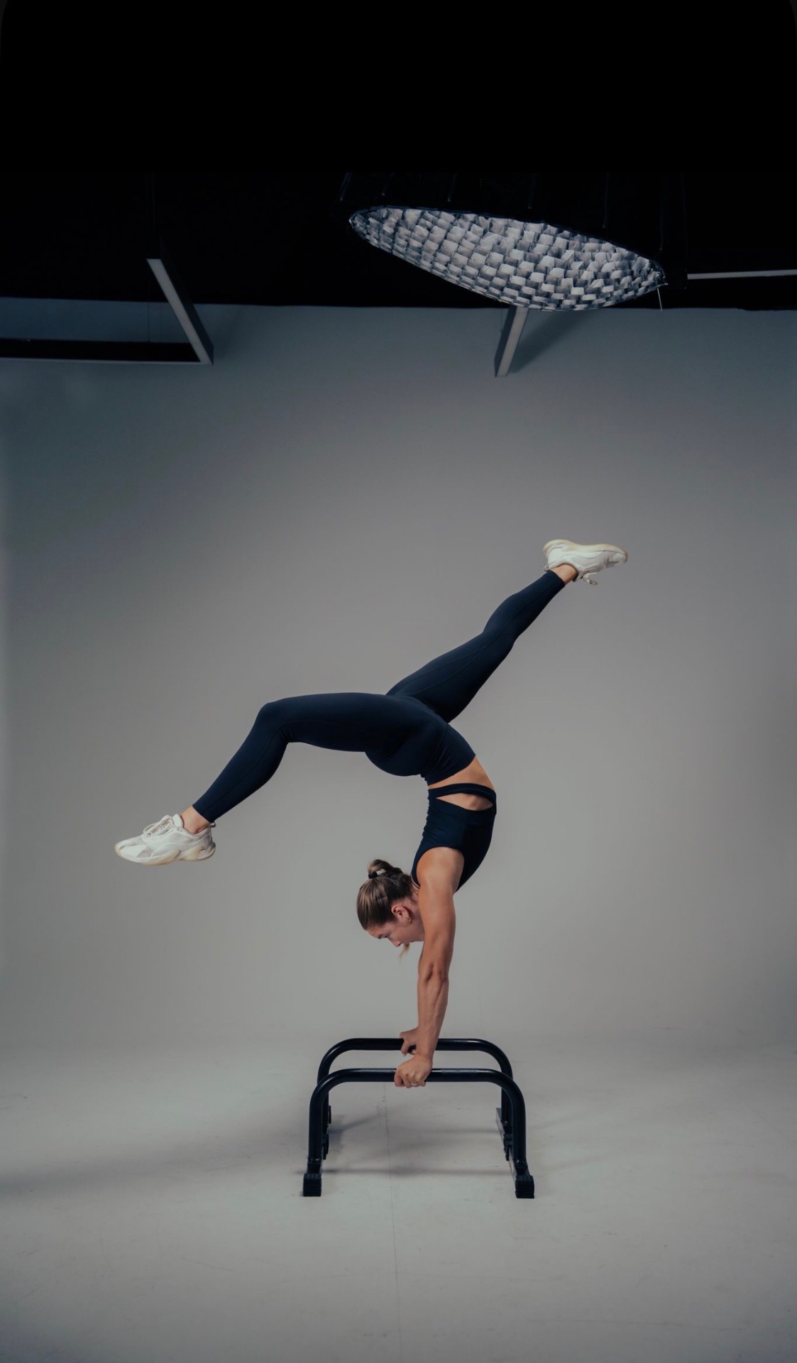 Athlete holding a handstand in the content studio