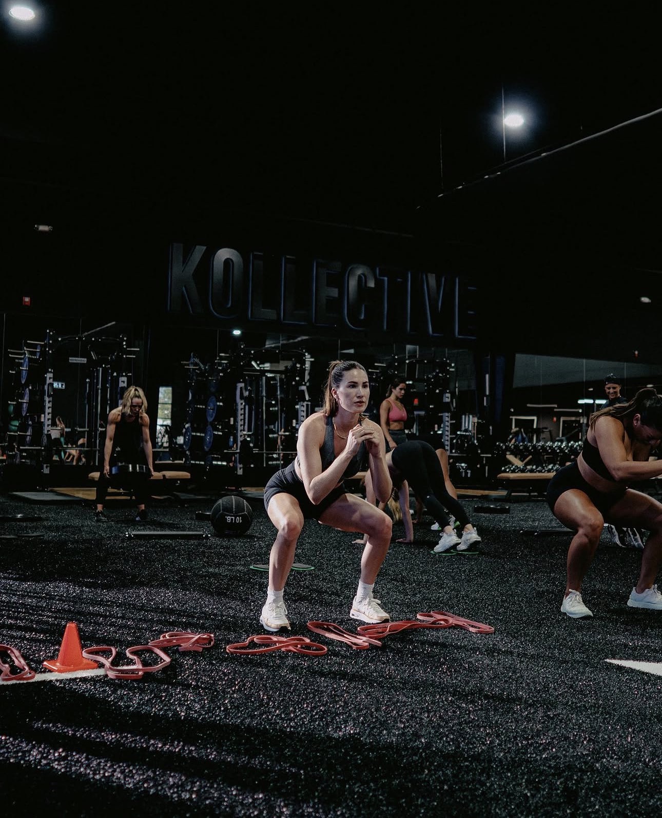 Members training on the performance floor with coaching